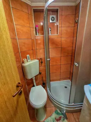 a small bathroom with a toilet and a shower at Vikendica RAJ in Travnik