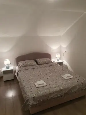 a bedroom with a bed with two towels on it at Vikendica Cokori in Banja Luka