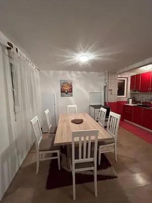a dining room table and chairs in a kitchen at Vikendica Cokori in Banja Luka