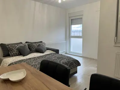 a living room with a couch and a table at 7th Sky in Doboj