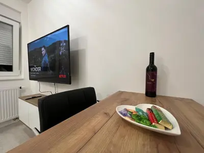 a table with a plate of food and a bottle of wine at 7th Sky in Doboj