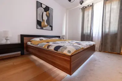a bedroom with a wooden bed in a room at Madonna Sky in Kupres