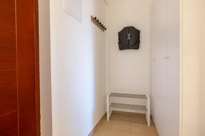 a hallway with a black clock on the wall at Madonna Sky in Kupres