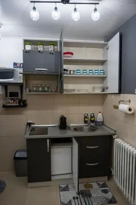 a kitchen with a sink and a counter top at APARTMAN POZORISTE Penthaus in Banja Luka