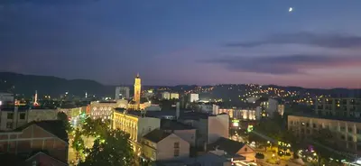 a view of a city at night with lights at APARTMAN POZORISTE Penthaus in Banja Luka