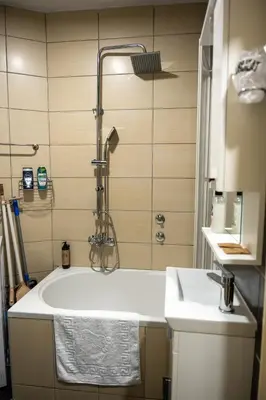 a bathroom with a tub and a shower and a sink at APARTMAN POZORISTE Penthaus in Banja Luka