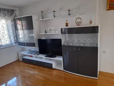 a living room with a entertainment center with a tv at Apartman Zoran in Livno
