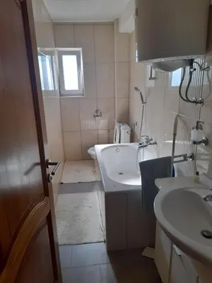 a bathroom with a sink and a tub and a toilet at Apartman Zoran in Livno