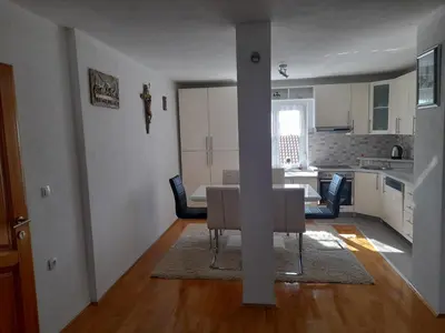 a dining room and kitchen with a table and chairs at Apartman Zoran in Livno