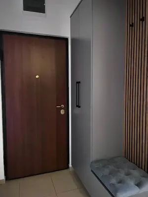 a brown door with a bench in front of it at APARTMAN MASA in Banja Luka
