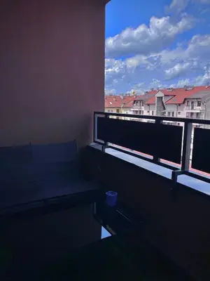 a room with a bench and a window with buildings at APARTMAN MASA in Banja Luka