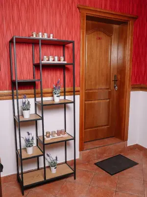 a room with three shelves with plants and a door at Stara Ada Banja Luka in Banja Luka