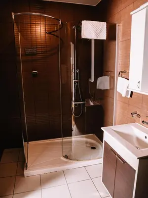 a shower with a glass door in a bathroom at Stara Ada Banja Luka in Banja Luka