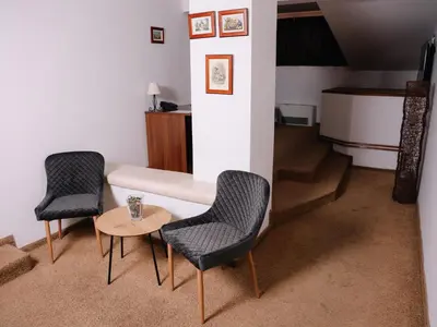 two chairs and a table in a room at Stara Ada Banja Luka in Banja Luka
