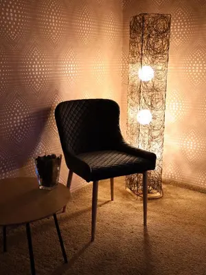 a chair in a room with a lamp and a table at Stara Ada Banja Luka in Banja Luka