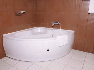 a bath tub with a faucet in a bathroom at Stara Ada Banja Luka in Banja Luka