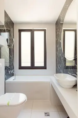 a white bathroom with two sinks and a tub at Bijele Vode spa&nature hotel in Prijedor