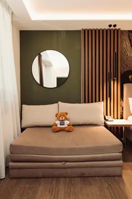 a teddy bear sitting on a bed in a bedroom at Bijele Vode spa&nature hotel in Prijedor