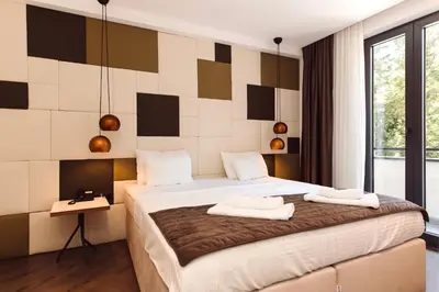 a bedroom with a bed with two towels on it at Bijele Vode spa&nature hotel in Prijedor