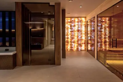 a bathroom with a glass door with lights in it at Bijele Vode spa&nature hotel in Prijedor