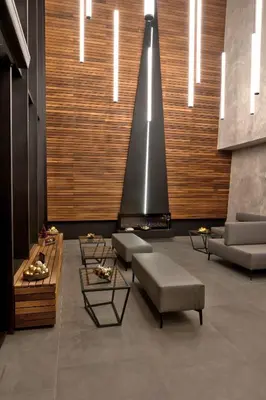a living room with a couch and a fireplace at Bijele Vode spa&nature hotel in Prijedor