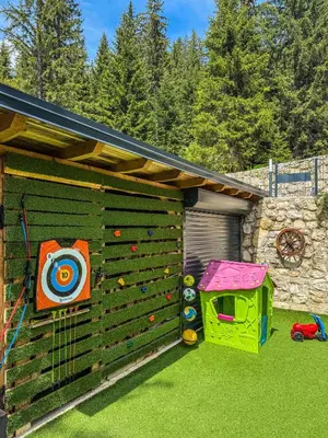 a backyard with a climbing wall and a play house at Vila Bašić Vlašić Apartman VUK in Vlasic
