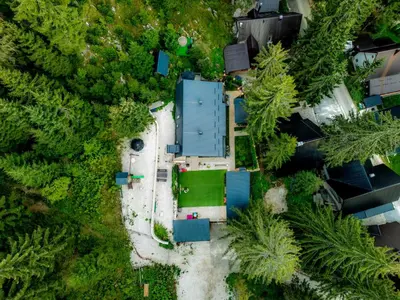 an overhead view of a building in a forest of trees at Vila Bašić Vlašić Apartman VUK in Vlasic