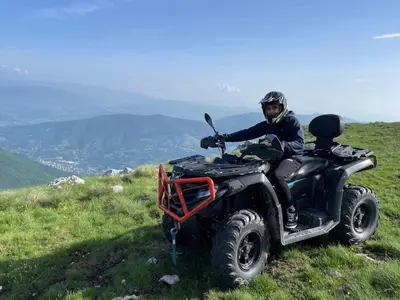 a person riding a quad bike on a hill at Vila Bašić Vlašić Apartman VUK in Vlasic