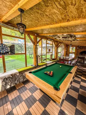 a room with a pool table in a house at Vila Bašić Vlašić Apartman MEDO in Vlasic