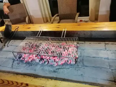 a table with a bunch of pink birds in a cage at Apartman LELI in Kupres