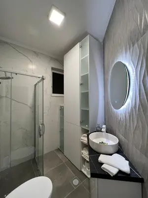 a bathroom with a sink and a mirror and a shower at Apartman Divine in Banja Luka