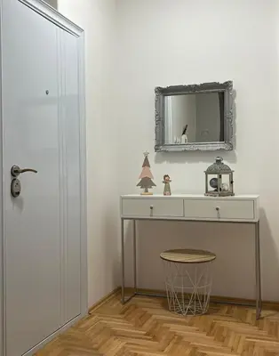 a bathroom with a vanity and a mirror on the wall at Apartman Divine in Banja Luka