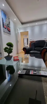 a living room with a couch and a television at Checkmate in Tešanj