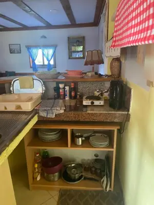 a toy kitchen with a counter top with dishes at Farma 2 in Cazin