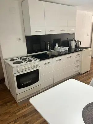 a kitchen with a white stove and a sink at Apartman MIA in Travnik