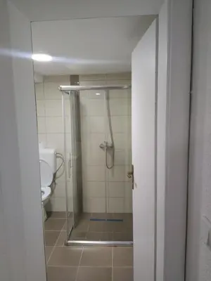 a bathroom with a shower and a toilet at Apartman MIA in Travnik