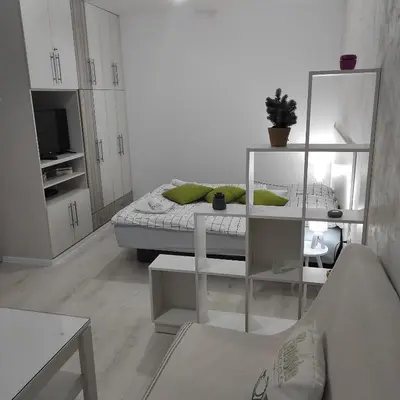 a white living room with a bed and a couch at Apartman Jevrejska Banja Luka in Banja Luka