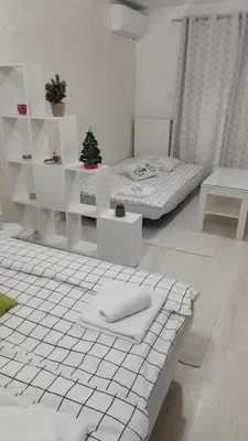 a white room with two beds and a christmas tree at Apartman Jevrejska Banja Luka in Banja Luka