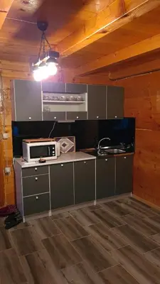 a kitchen with a stove and a microwave at Planinske kolibe Šipovo in Šipovo
