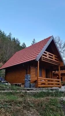 a log cabin with a red roof at Planinske kolibe Šipovo in Šipovo