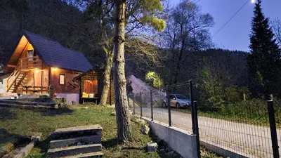 a house with a car parked in front of it at Planinske kolibe Šipovo in Šipovo