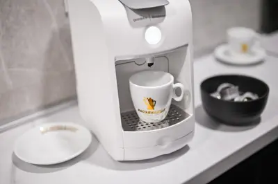 a coffee maker sitting on a counter with a coffee cup at Apartman City Charm in Banja Luka