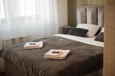 a bedroom with two towels on a bed at Apartman City Charm in Banja Luka