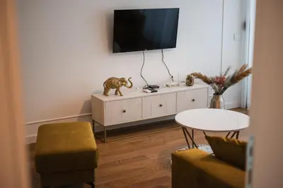 a living room with a tv on top of a cabinet at Apartman City Charm in Banja Luka