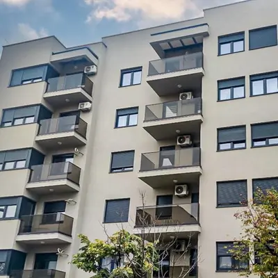 a tall building with balconies on the side of it at Apartman Venecija De Lux in Banja Luka