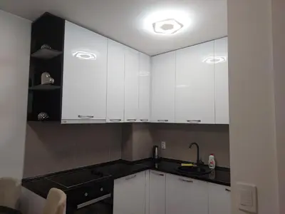 a kitchen with white cabinets and a sink at Apartman Venecija De Lux in Banja Luka