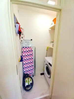 a small laundry room with a washer and dryer at Ena Apartment in Tuzla