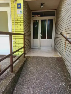 a front door of a building with a door gmaxwell gmaxwell gmaxwell at Ena Apartment in Tuzla