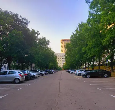 a row of cars parked in a parking lot at Ena Apartment in Tuzla