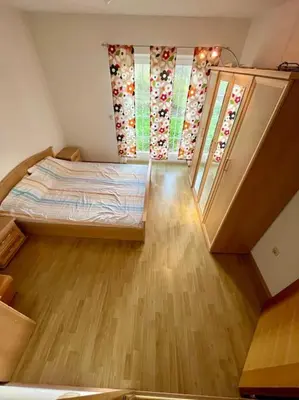 a small room with a bed and two windows at Villa TeslaS in Velika Kladuša